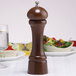 A Chef Specialties Windsor Walnut pepper mill on a table.