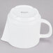 A white porcelain teapot with a lid and handle.