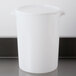 A white plastic Carlisle food storage container lid on a white plastic container.