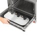 A hand opening a Vollrath countertop convection oven.