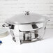 A Vollrath stainless steel large oval chafer with a lid.