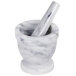 A white marble mortar and pestle set.