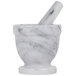A white marble mortar and pestle set.