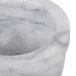 A close up of a Thunder Group white marble mortar bowl.