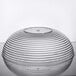 A clear Cambro round bowl with ribbed design on top.