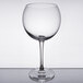 A clear Chef & Sommelier wine glass on a reflective surface with a white rim.