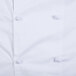 A close up of a white Mercer Culinary long sleeve chef jacket with cloth knot buttons.