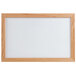 An Aarco oak framed white marker board.