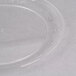A WNA Comet clear plastic plate with a circular design on a white surface.