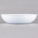 A white bowl with a black border on a white surface.