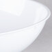 A close-up of a white Fineline plastic round bowl.