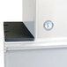 The black rectangular surface of a Hoshizaki ice machine top kit with a white logo of a penguin.