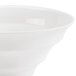 A close up of a CAC bone white porcelain bowl with a white rim.