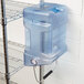 A blue Rubbermaid ice tote on a shelf above a water dispenser.
