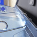 A close-up of a blue Rubbermaid plastic ice tote with a handle.