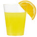 A Fineline clear plastic tumbler filled with orange juice and a slice of orange on the side.