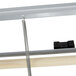 A gray metal horizontal paper cutter rack with a metal rod and wire attached to it.