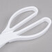 White plastic salad tongs with handles.