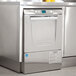 A stainless steel Hobart LXeC-3 undercounter dishwasher in a professional kitchen.