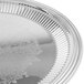 A Vollrath stainless steel round fluted serving tray.