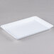A white rectangular tray with a scalloped edge.