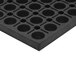A black rubber Cactus Mat with holes in it.