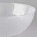 A clear plastic bowl with a curved edge.
