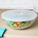 A Fineline clear plastic bowl filled with salad.