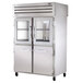 A large stainless steel True pass-through refrigerator with half glass front and half solid doors.