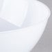 A close up of a white Fineline Plastic Round Bowl with a white rim.