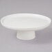 A 10 Strawberry Street Whittier white porcelain cake stand with a bowl on top.