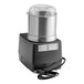 A black and silver Robot Coupe food processor with a lid.