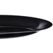 A close-up of a Fineline black plastic oval tray.