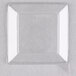 A clear square lid on a white surface over a white rectangular object.