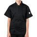 A young woman wearing a Mercer Culinary black chef coat.