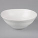 A 10 Strawberry Street white stoneware serving bowl with a curved edge.