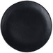 A close-up of a black 10 Strawberry Street matte wave stoneware plate.