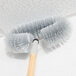 A Carlisle gray wall and ceiling duster brush with a long handle.