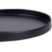A black round 10 Strawberry Street stoneware tray with a wavy design.