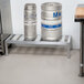 A Channel KDR148 keg dunnage rack holding two metal kegs.
