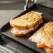 Two sandwiches being grilled on a Galaxy Panini Grill.