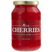 A jar of Regal Maraschino Cherries with stems in red liquid.