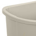 A beige Rubbermaid half round plastic trash can with a lid.