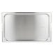 A Vollrath stainless steel rectangular pan cover with handles on a stainless steel tray.
