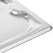 A Vollrath stainless steel cover with a small hole in the middle.