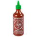 A 17 oz. bottle of Huy Fong Sriracha Hot Chili Sauce with a green lid and a rooster on the label.