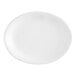 An Acopa bright white oval stoneware platter with a small rim.