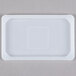 A white rectangular Flexsil steam table pan lid with a square in the middle.