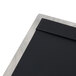 A close-up of a Menu Solutions Alumitique aluminum menu board with black and silver swirl finish.