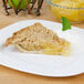 A slice of Lucky Leaf apple pie on a plate.